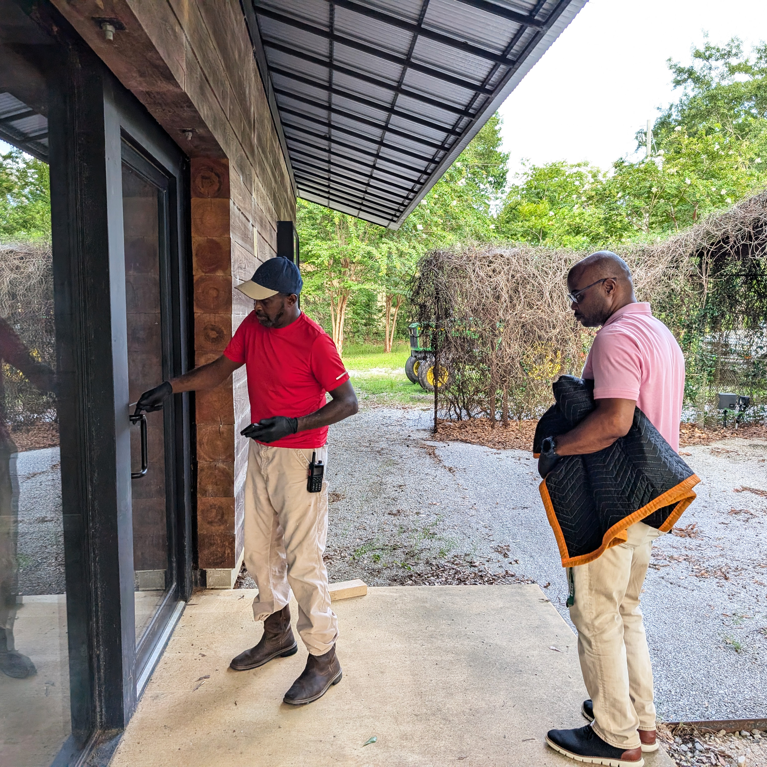 two men stepping into a building