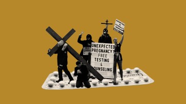 anti-abortion protestors hold crosses and signs