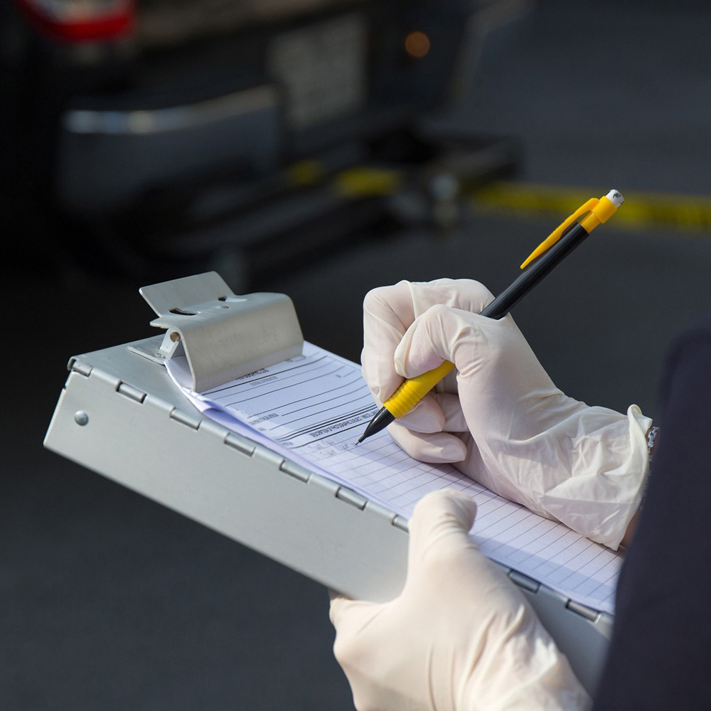 Person in gloves write on a clipboard